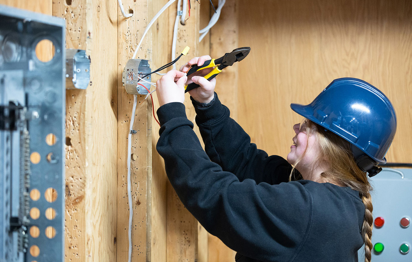 A student works at an electrical panel